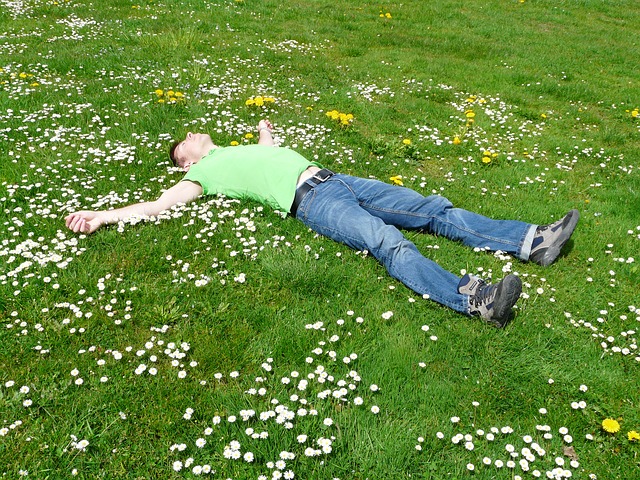 man lying on field of clover
